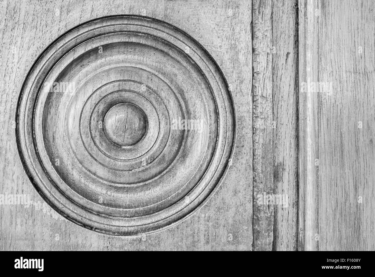 Black and White image of an antique circular wooden panel. Stock Photo