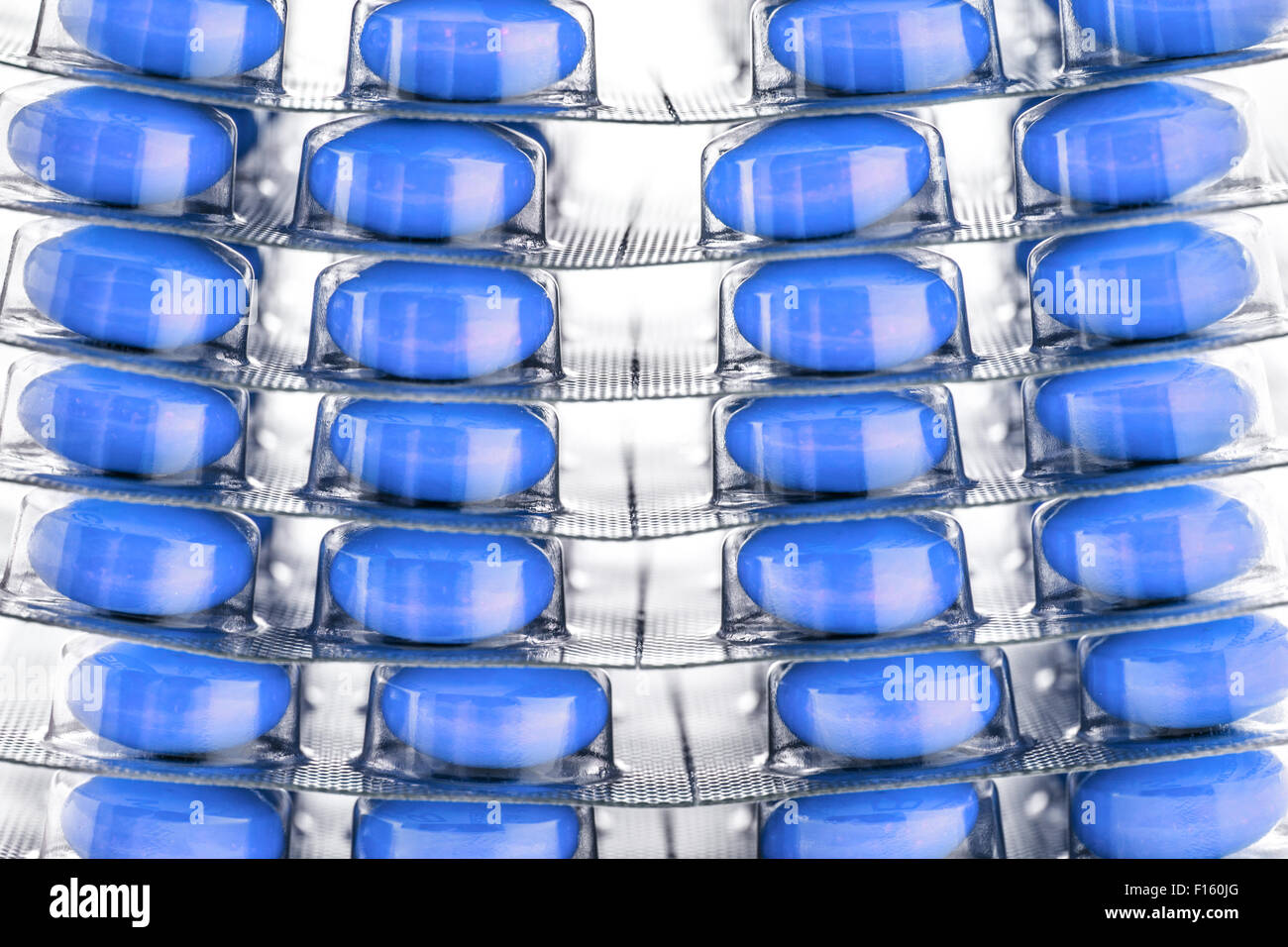 Blue tablets in plastic packing as background Stock Photo