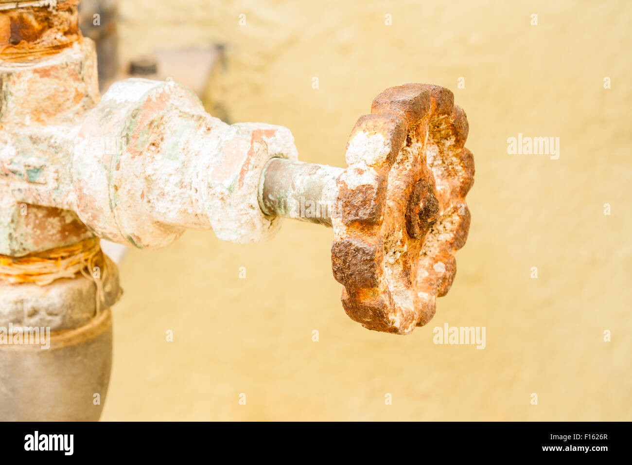 Closeup view of a gate valve that is covered with rust. Stock Photo