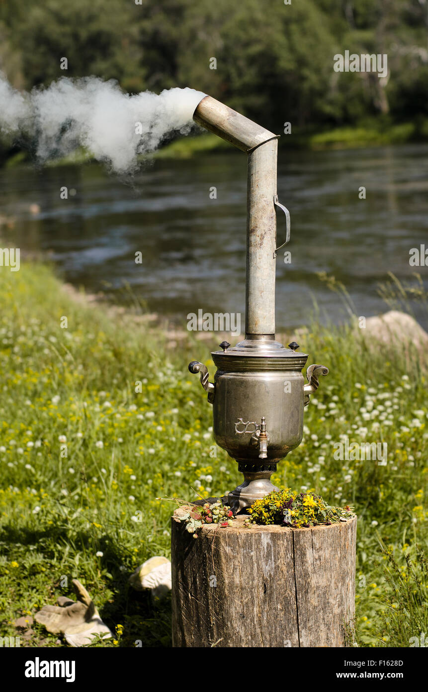 iron, antique russian samovar to boil on nature, vertical photo Stock Photo