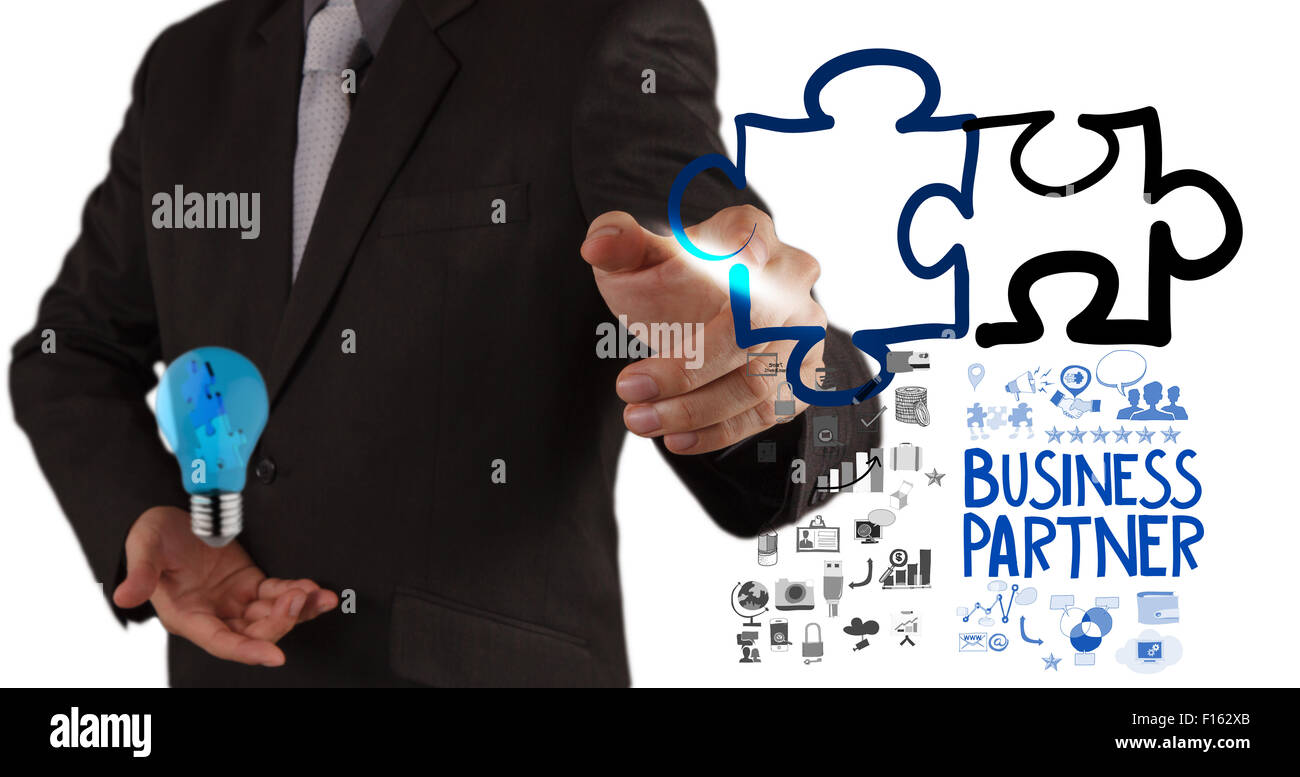 businessman hand drawing Partnership Puzzle Concept Stock Photo - Alamy