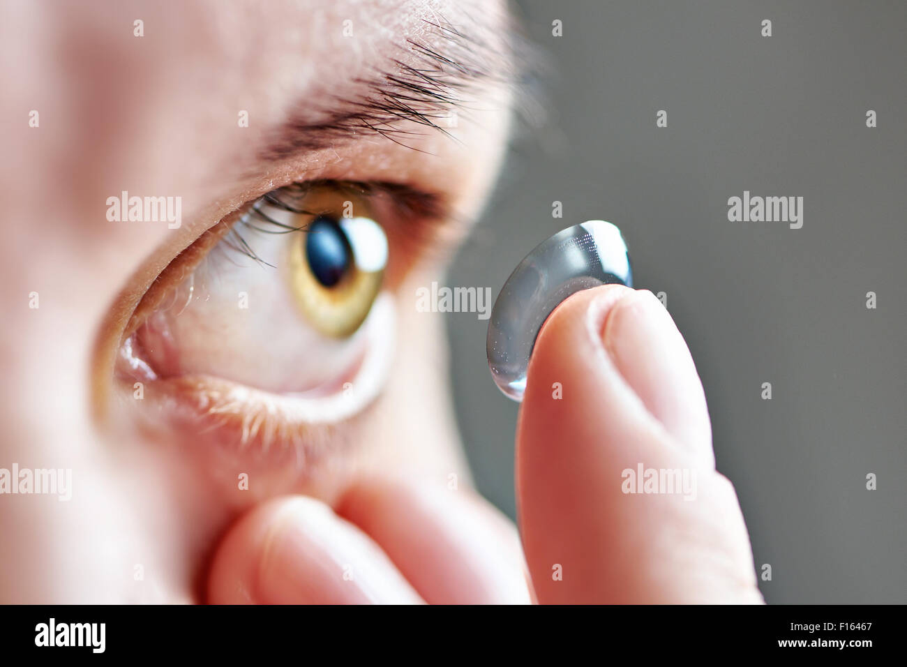 Medicine and vision - young woman with contact lens Stock Photo