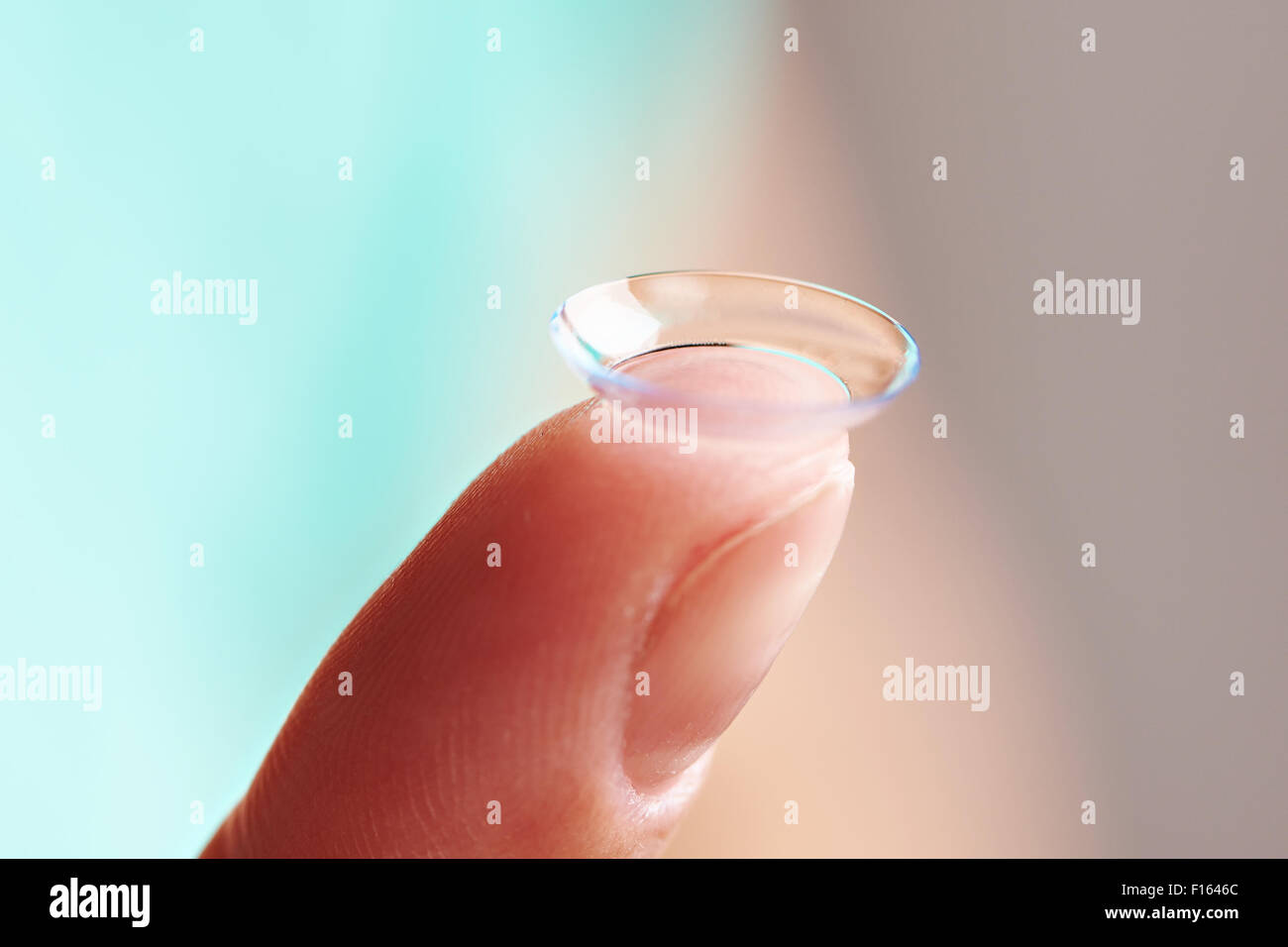 Medicine and vision - womans finger with contact lens Stock Photo