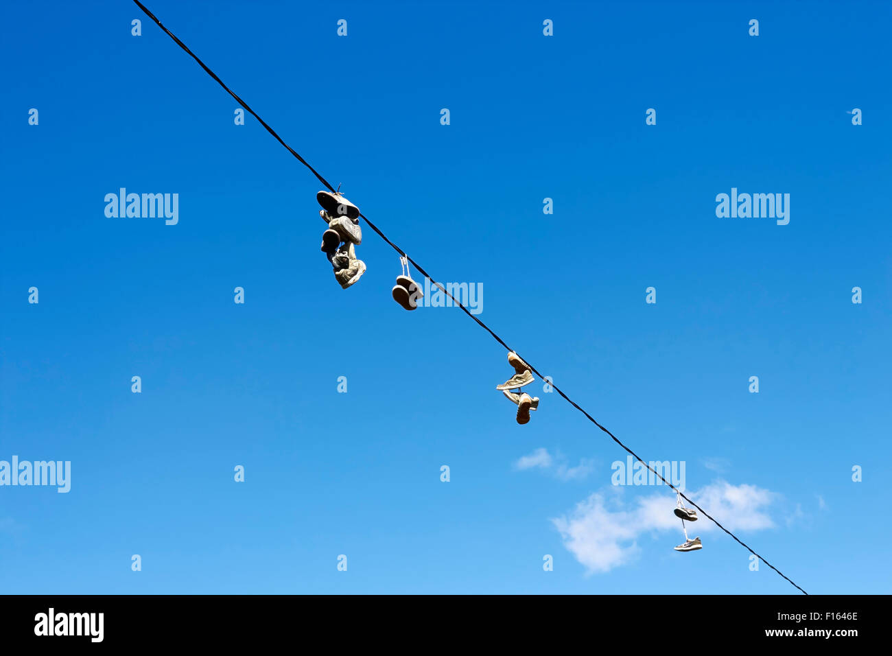 shoes hanging from a electric wire Stock Photo