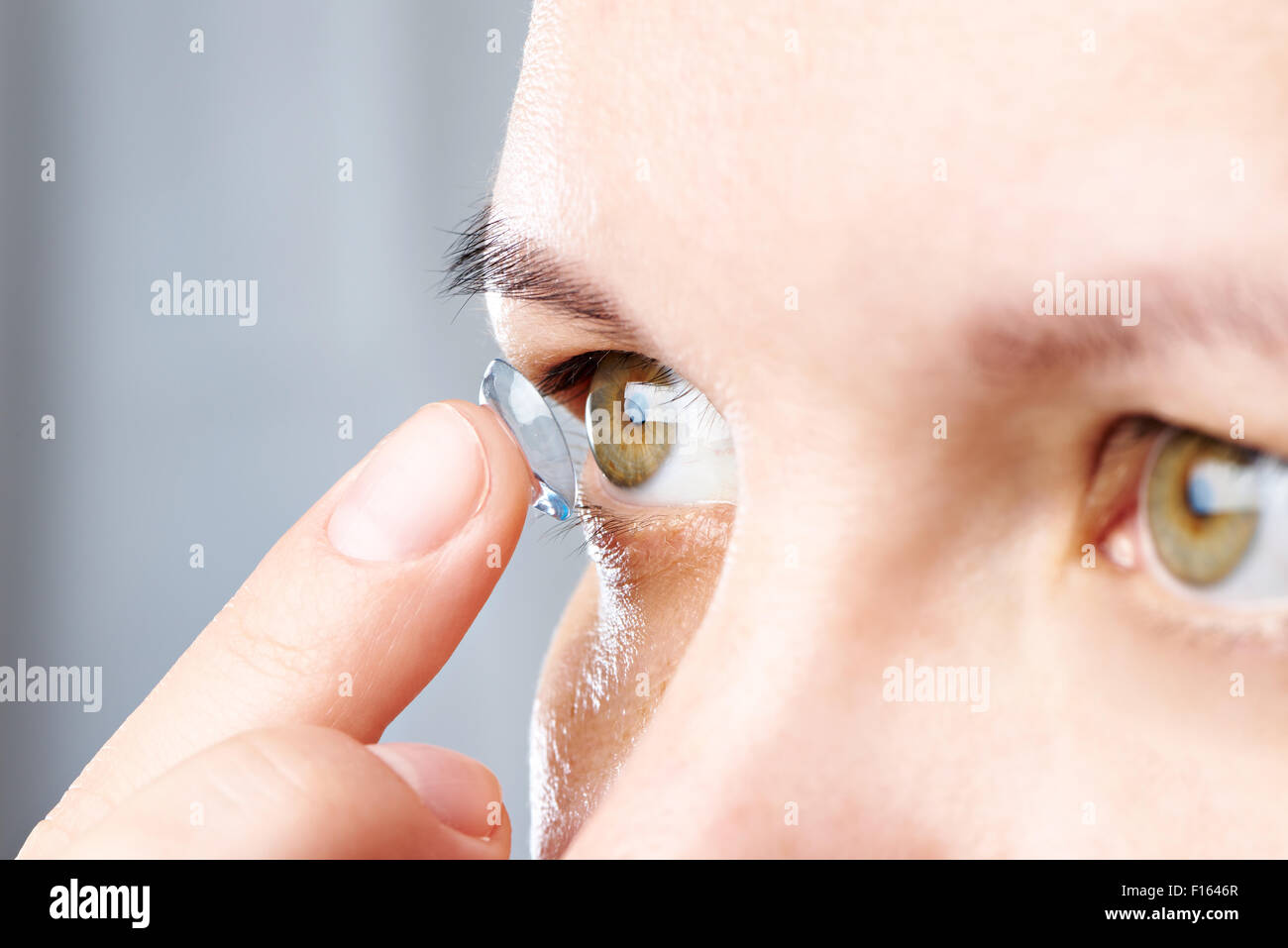 Medicine and vision - young woman with contact lens Stock Photo