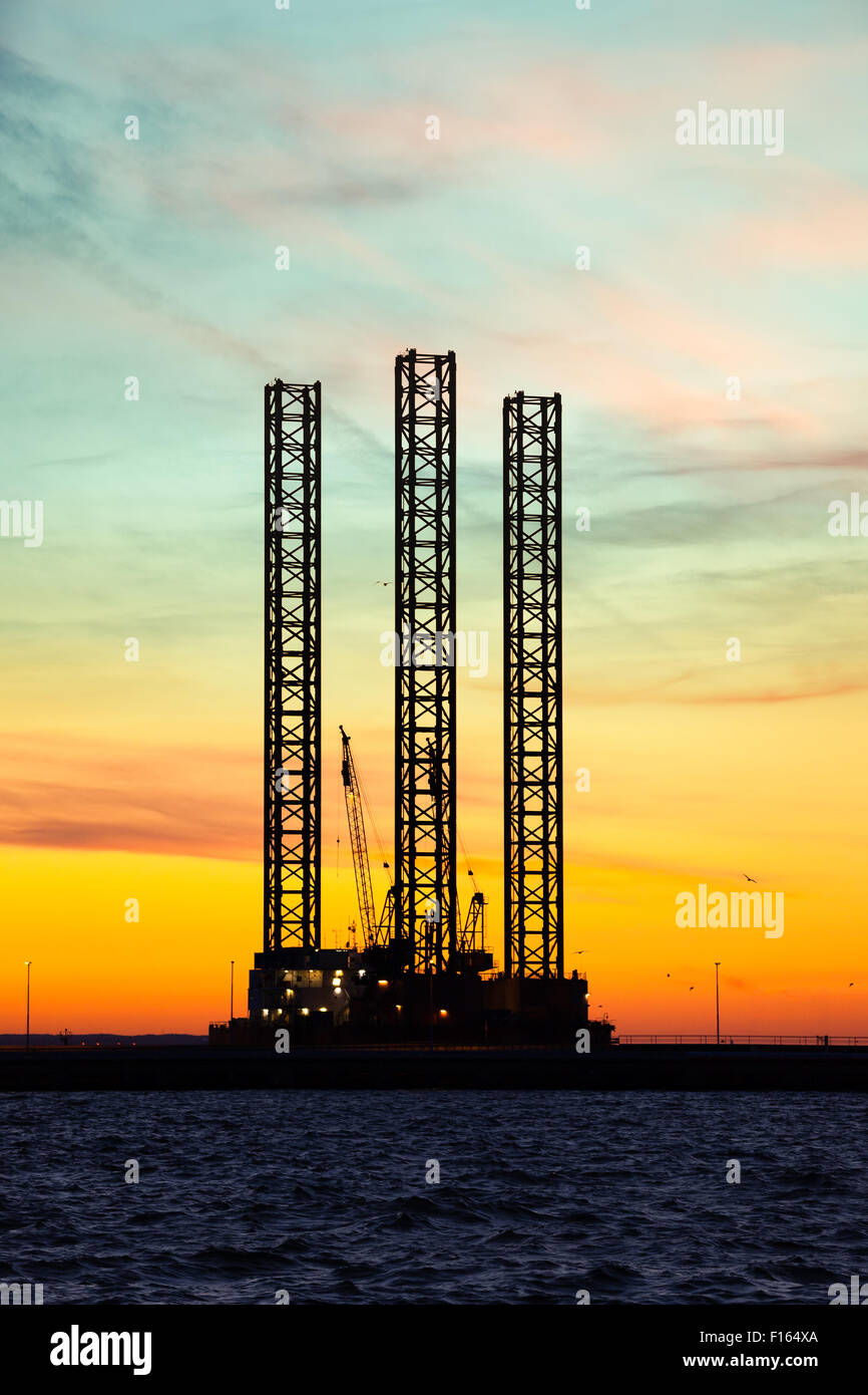 Oil drilling rig at sunset time. Stock Photo