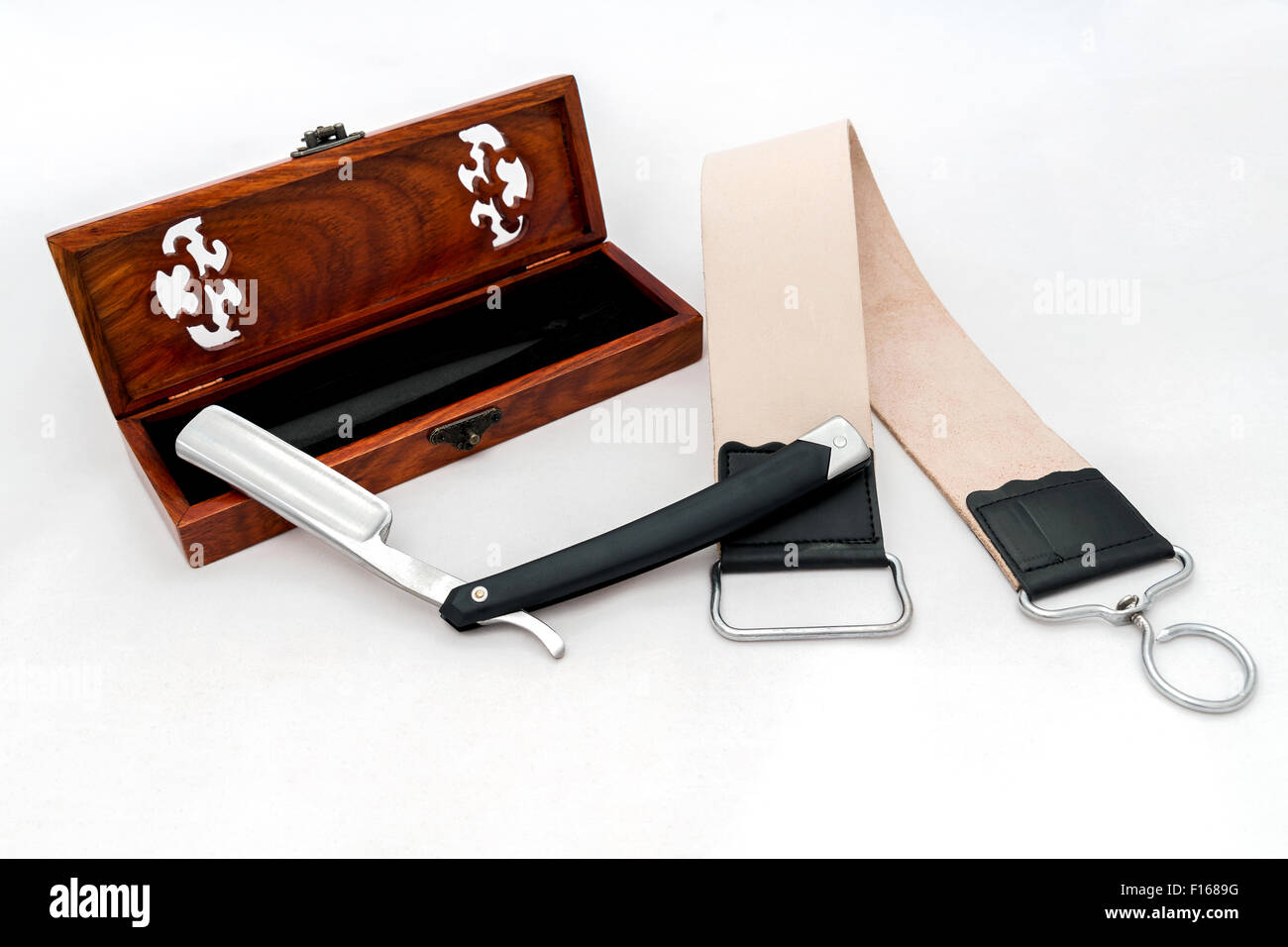 Open razor with wooden box and leather strap Stock Photo