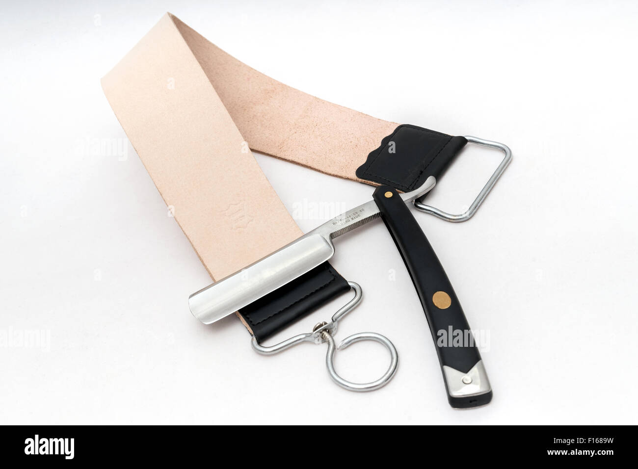 Open razor with leather strap Stock Photo