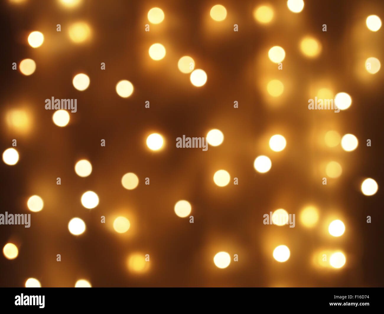 Abstract image - round, yellow and dim lights of different brightness to  dark yellow background. They blurred for use as a wallp Stock Photo - Alamy