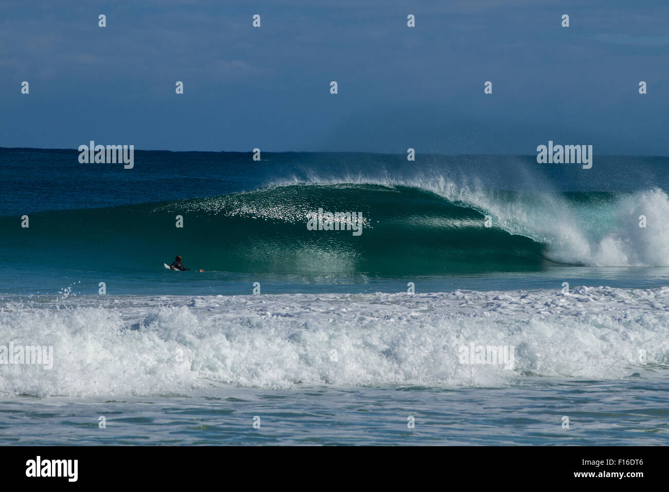 A perfect empty barrel rolls through a pristine beach in the south west