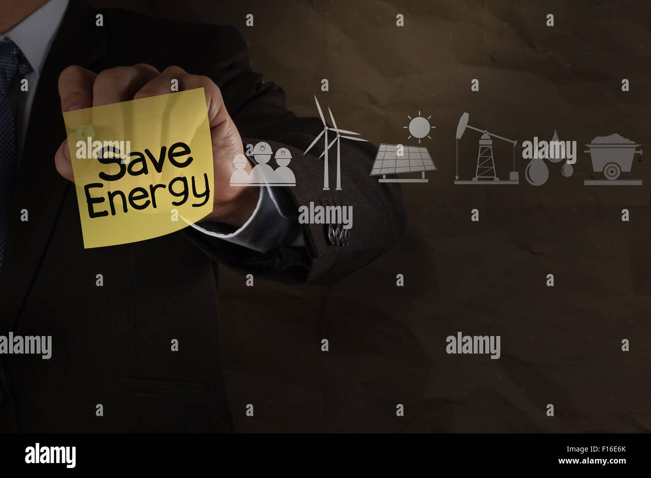 businessman hand draws save energy on sticky note with icons and ...