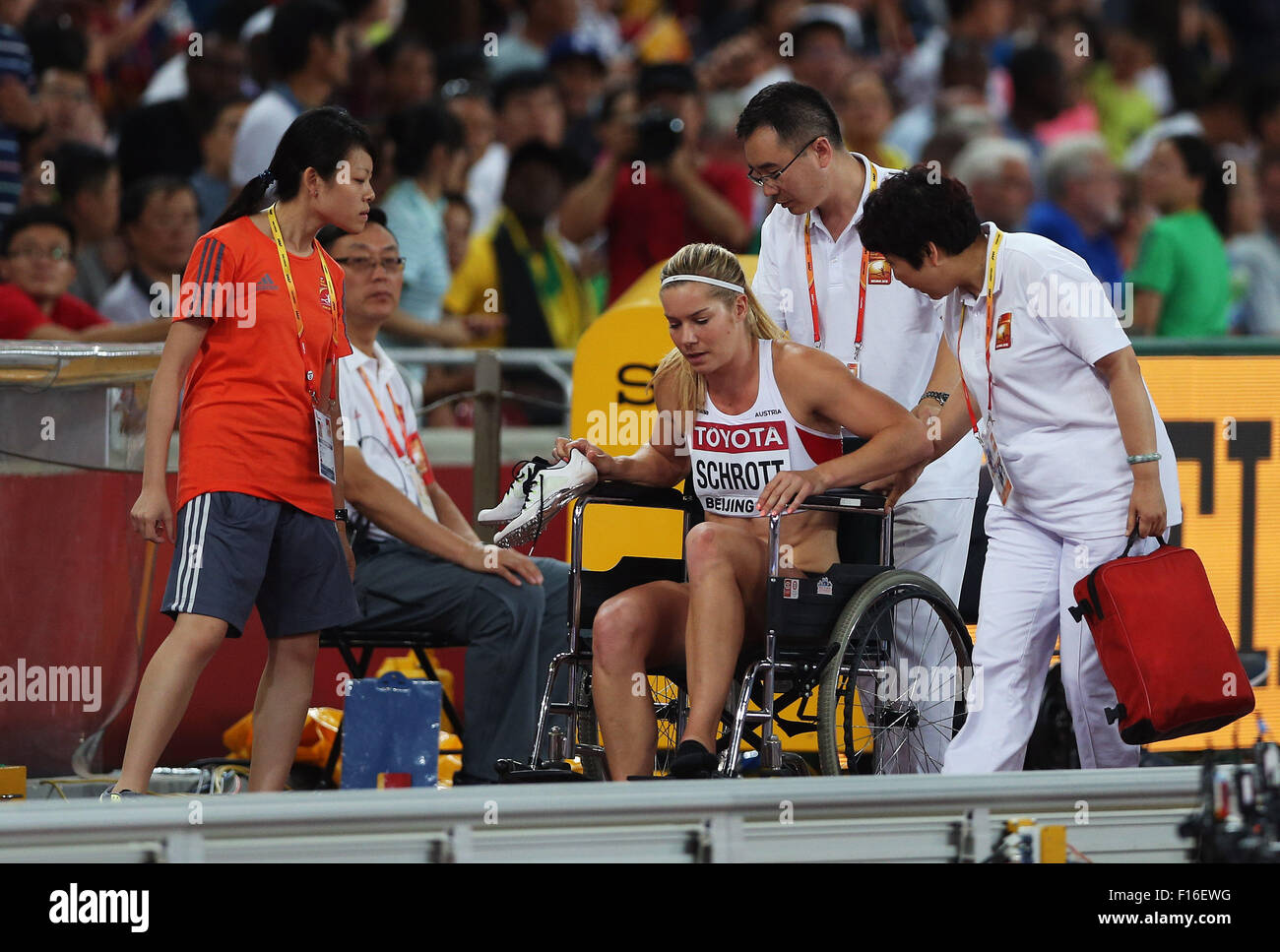 Beijing, China. 28th Aug, 2015. Austria's Beate Schrott leaves the stadium in a wheelchair after falling during the women's 100m hurdles semifinal at the 2015 IAAF World Championships at the 'Bird's Nest' National Stadium in Beijing, capital of China, Aug. 28, 2015. Credit:  Cao Can/Xinhua/Alamy Live News Stock Photo