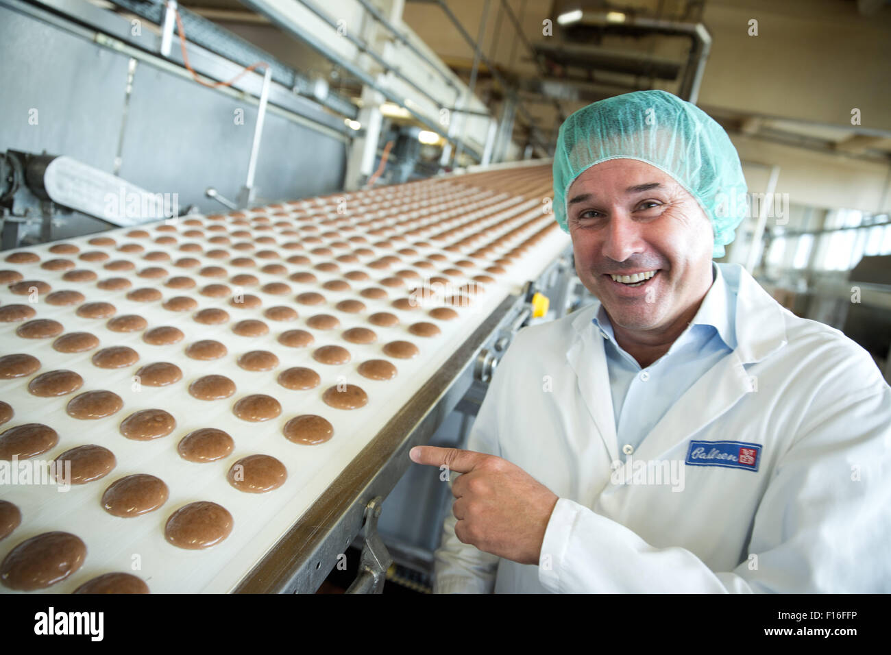 Berlin, Germany. 28th Aug, 2015. Michael Haehnel, General Manager of Bahlsen Germany, poses next to the production line at the Bahlsen factory in Berlin, Germany, 28 August 2015. The meteorologic beginning of autumn is in the beginning of September - christmas biscuits will be sold again at the same time. PHOTO: JOERG CARSTENSEN/dpa/Alamy Live News Stock Photo
