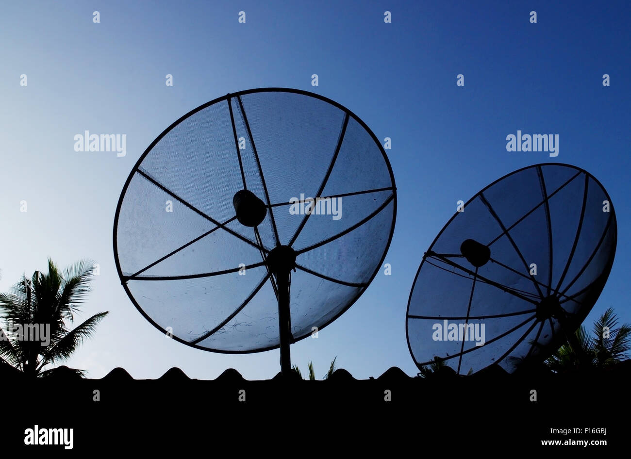 Silhouette telecommunication satelite dish with blue sky Stock Photo