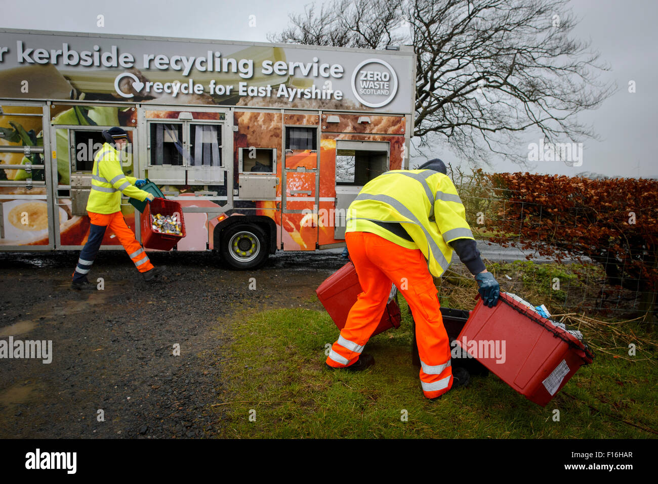 Kerbside recycling collection lorry and workers in rural area Stock