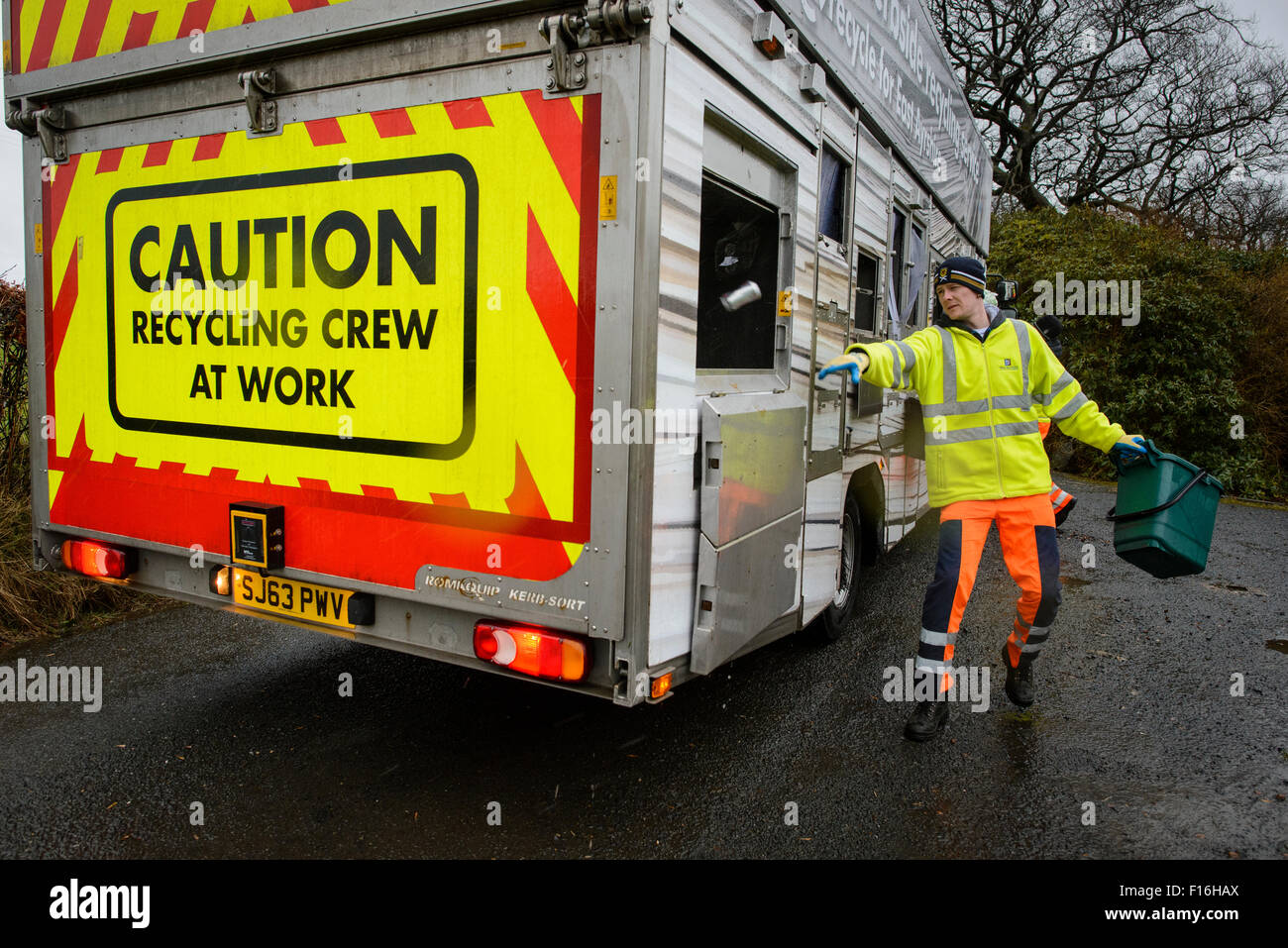Kerbside recycling collection lorry and workers in rural area Stock
