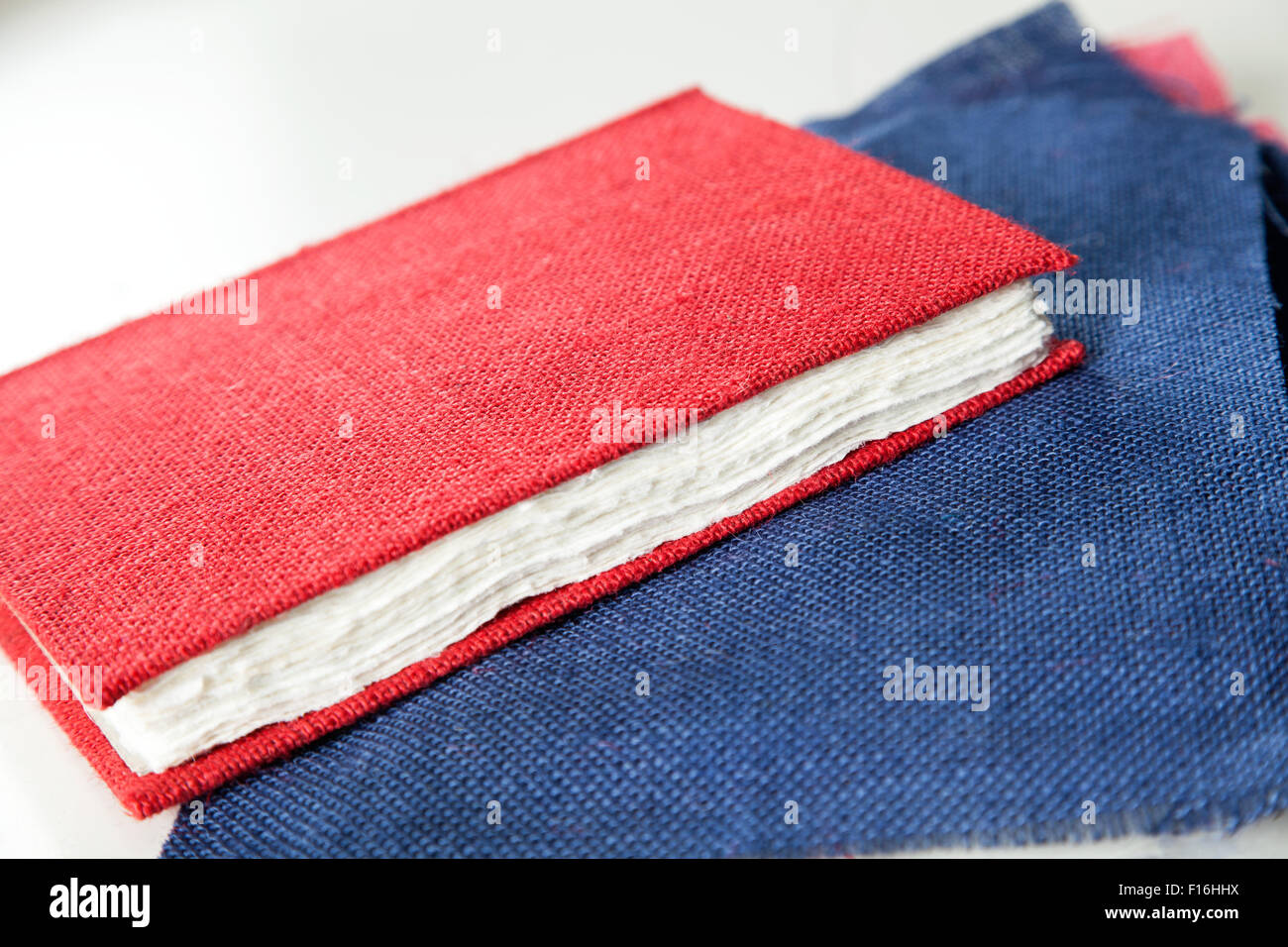 Fabric and red cover book on table in factory stock photo alamy