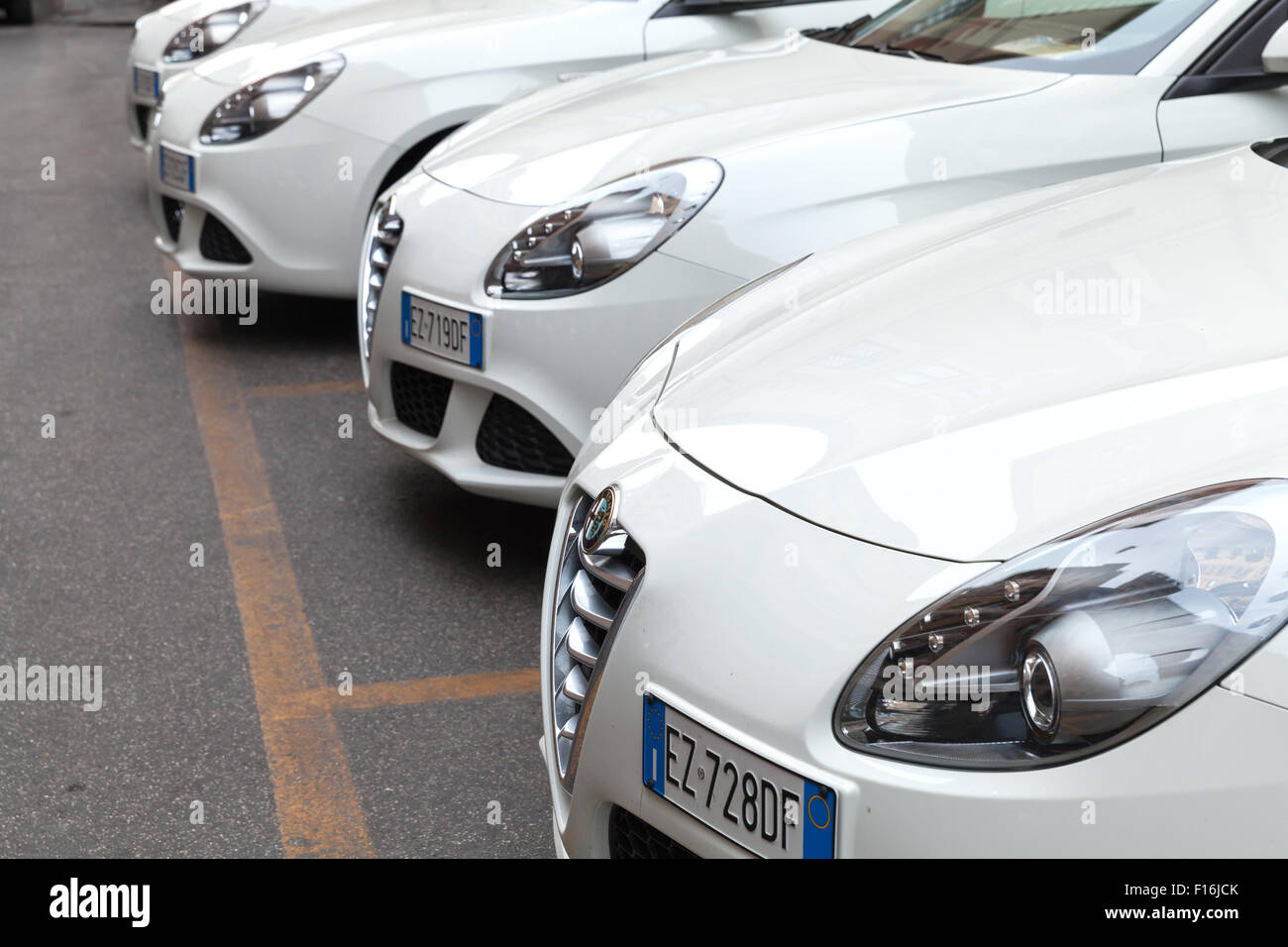 Rome, Italy - August 7, 2015: White Alfa Romeo Giulietta Type 940 cars stands parked in a row Stock Photo