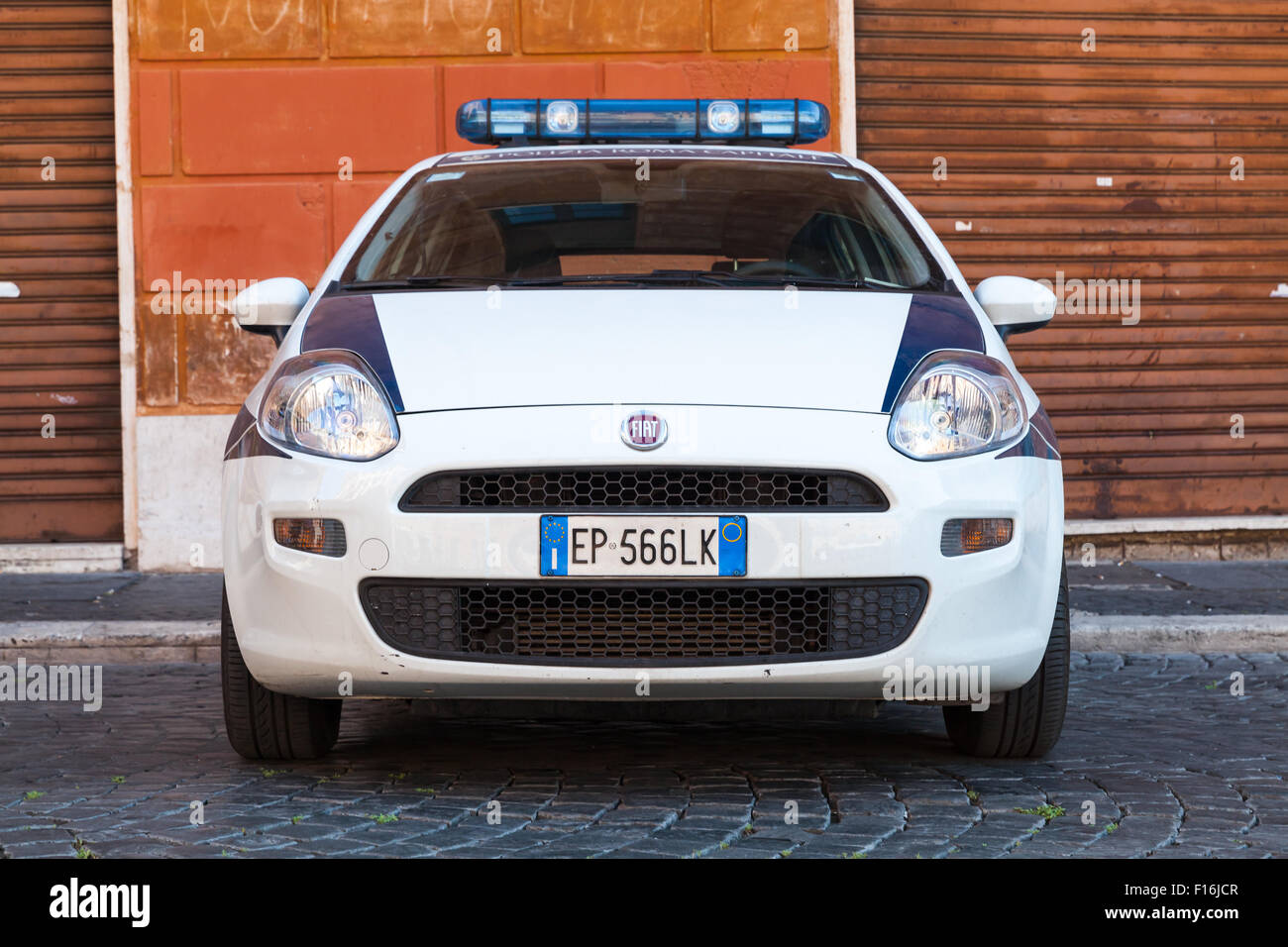 Rome, Italy - August 8, 2015: White Fiat Fiat Grande Punto police car stands parked on the city roadside, front view Stock Photo