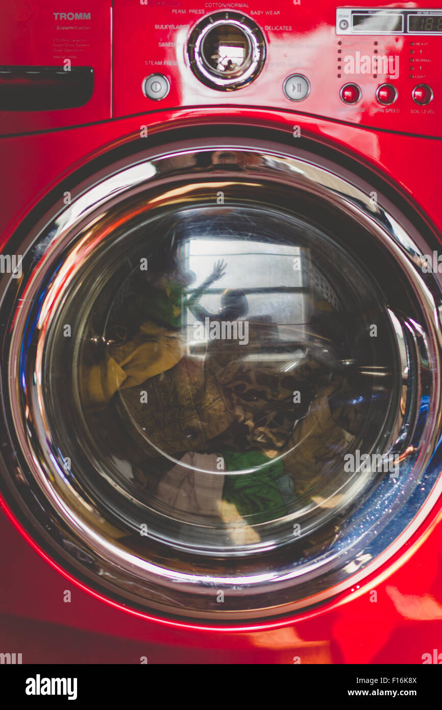 Reflection in washing machine shows hires stock photography and images