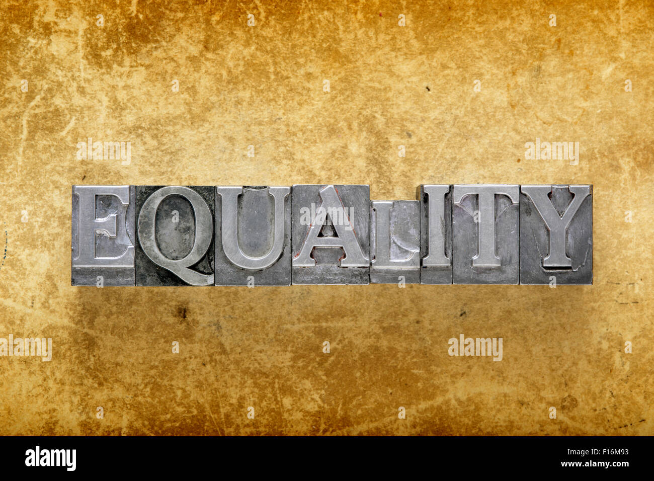 equality word made from metallic letterpress type on vintage cardboard Stock Photo