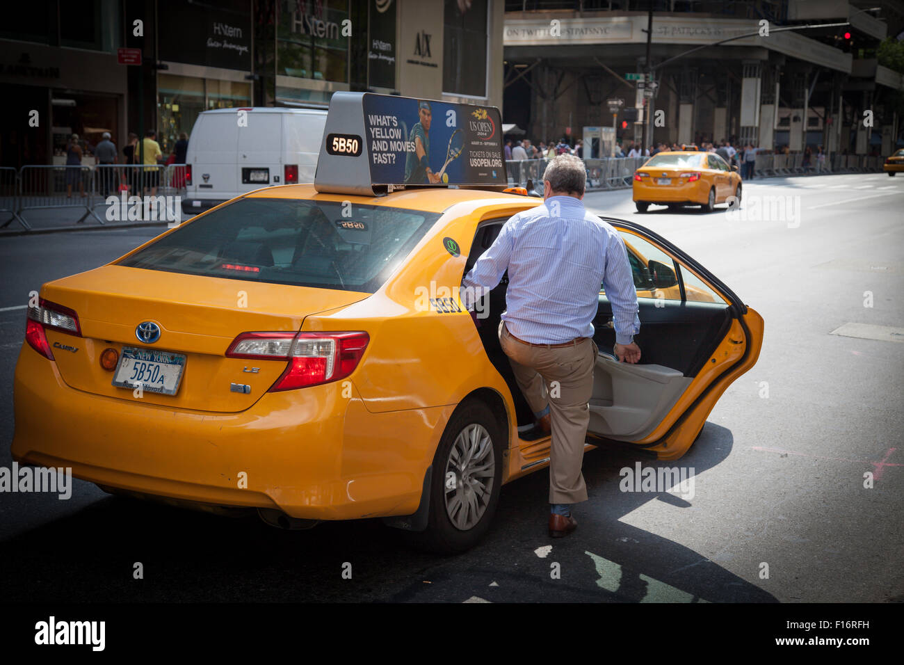 Male person taking a yellow cab in New York City Stock Photo