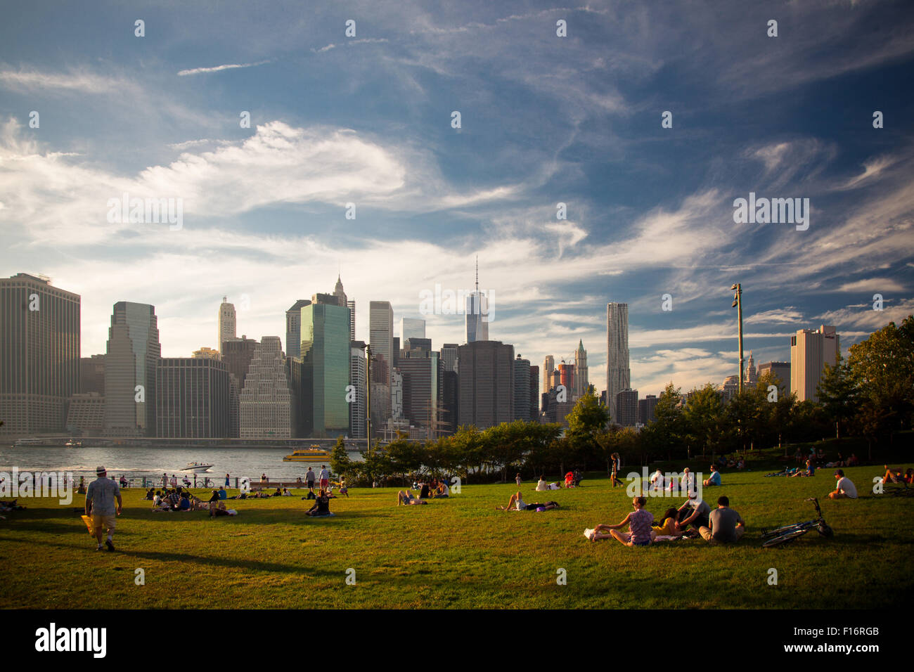 New Yorker enjoying the sunset at Brooklyn Bridge Park Stock Photo