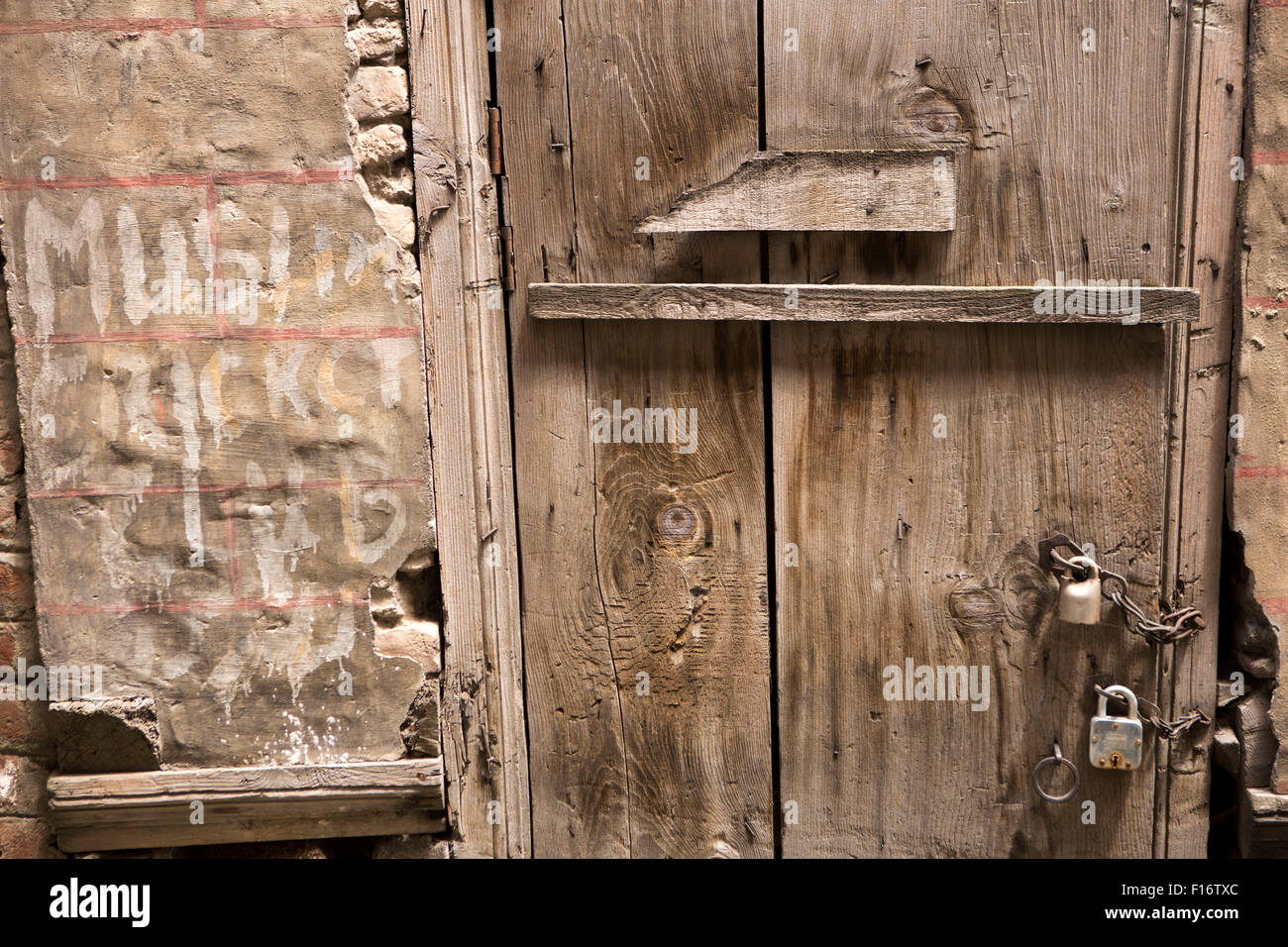 India, Jammu & Kashmir, Srinagar, old city, Khankah i Moulla, Muslim Cricket Club sign and rough wooden door Stock Photo