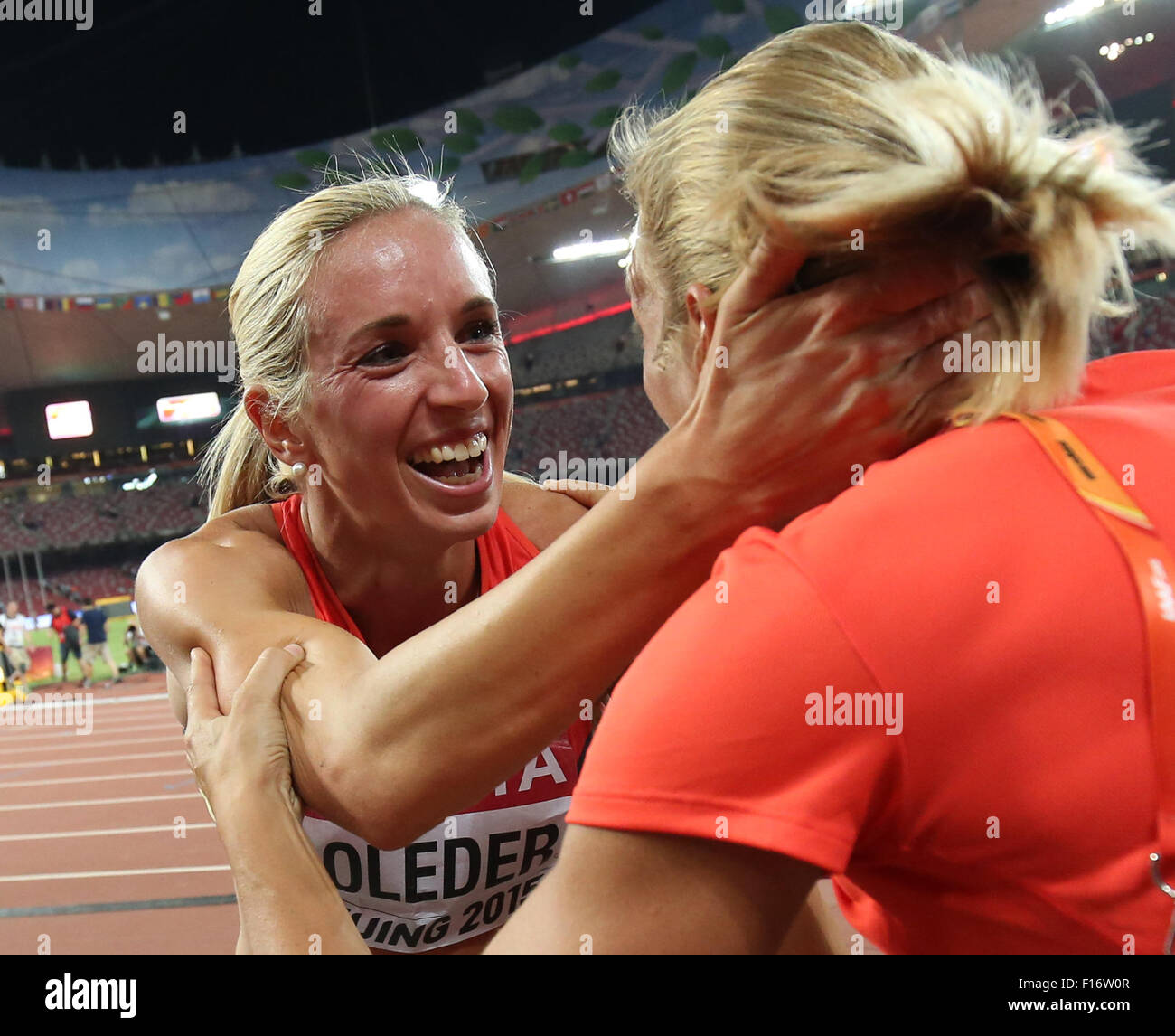 Beijing, China. 28th Aug, 2015. Cindy Roleder of Germany celebrates with German heptathlete Jennifer Oeser (R) after winning the silver medal in the women's 100m Hurdles final at the Beijing 2015 IAAF World Championships at the National Stadium, also known as Bird's Nest, in Beijing, China, 28 August 2015. Photo: Christian Charisius/dpa/Alamy Live News Stock Photo