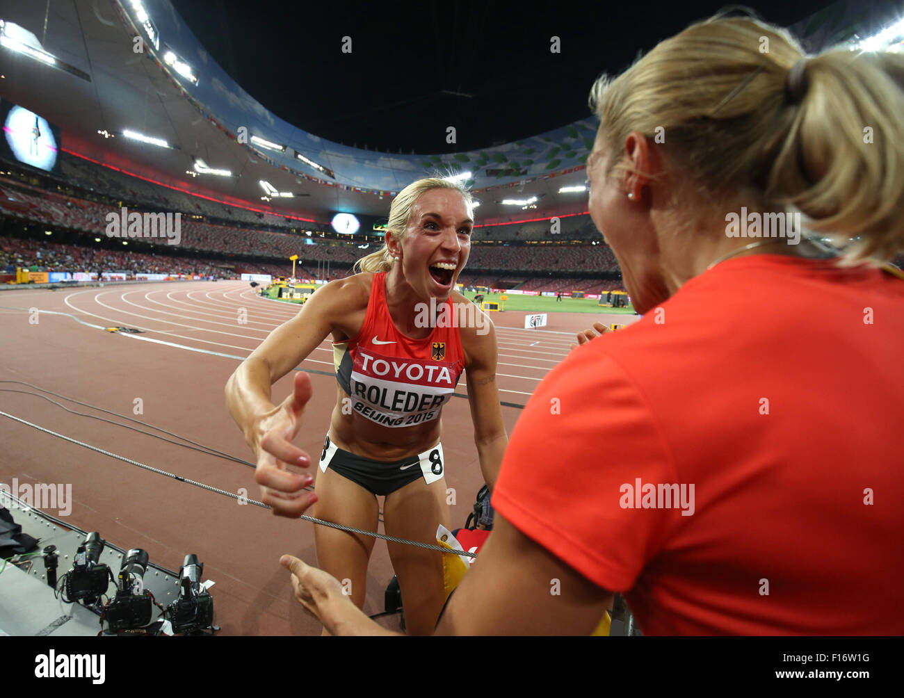 Beijing, China. 28th Aug, 2015. Cindy Roleder of Germany celebrates with German heptathlete Jennifer Oeser (R) after winning the silver medal in the women's 100m Hurdles final at the Beijing 2015 IAAF World Championships at the National Stadium, also known as Bird's Nest, in Beijing, China, 28 August 2015. Photo: Christian Charisius/dpa/Alamy Live News Stock Photo