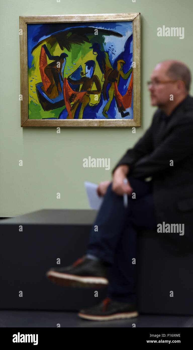 A man sits in front of the painting 'Fischer mit Netzen' (1921) by Karl Schmidt-Rottluff, during a preview at the Kunstmuseum Moritzburg art museum in Halle/Saale, Germany, 28 August 2015. A new permanent exhibition of pieces from the Gerlinger collection, titled 'Kraft des Aufbruchs', featuring work by Heckel, Kirchner, Schmidt-Rottluff, Mueller and Pechstein, opens on 30 August 2015. PHOTO: HENDRIK SCHMIDT/ZB Stock Photo