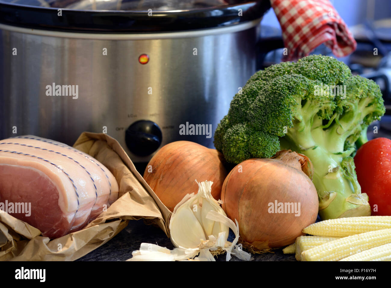 Fresh whole ingredients in front of a slow cooker pot Stock Photo