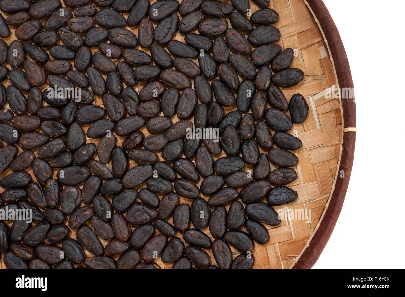 Cocoa beans from Madagascar in craft basket. Stock Photo