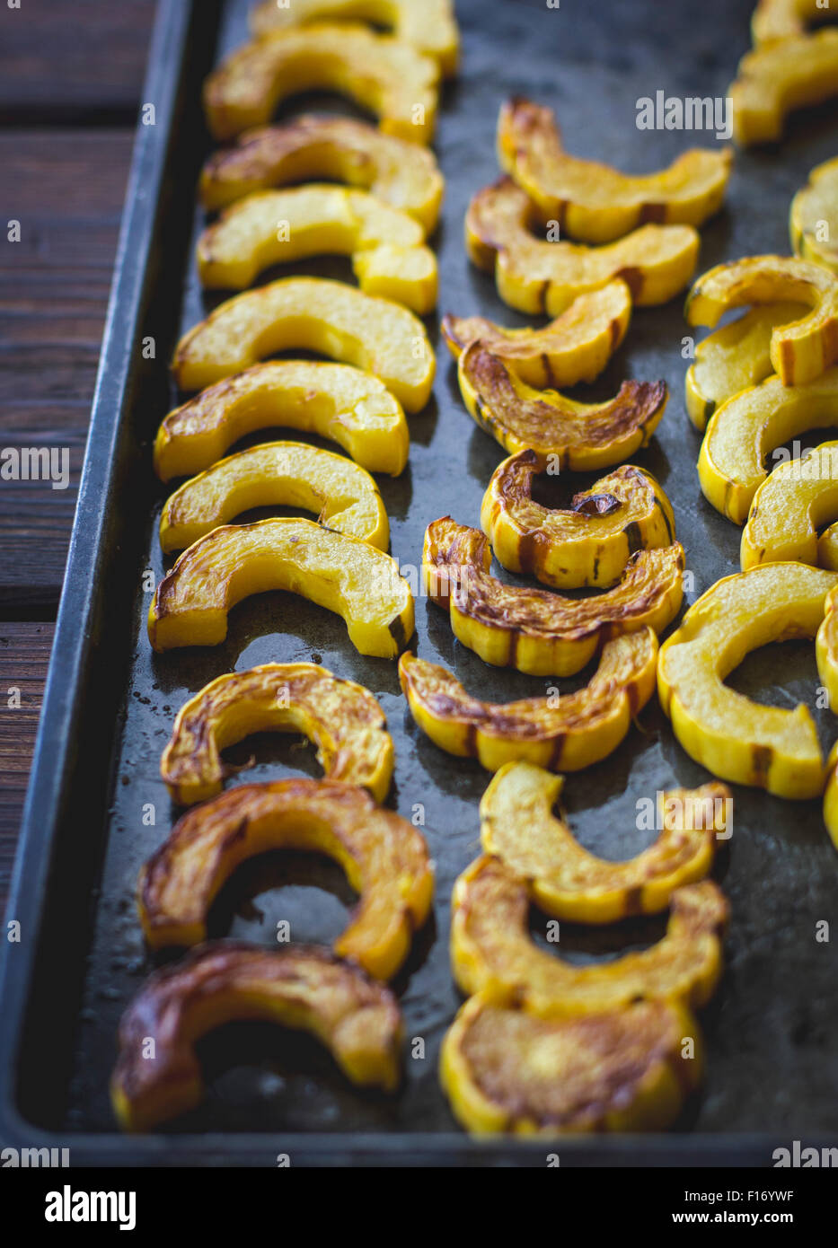 Roasted delicata squash slices on a pan. Stock Photo