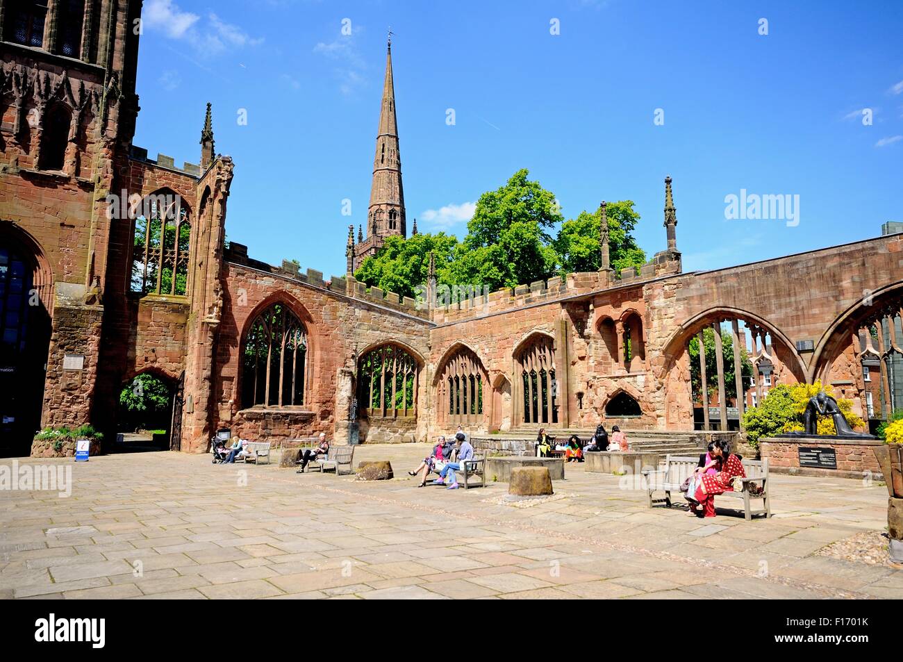 View inside the old Cathedral ruin with the Holy Trinity Church spire to the rear, Coventry, West Midlands, England, UK, Europe. Stock Photo