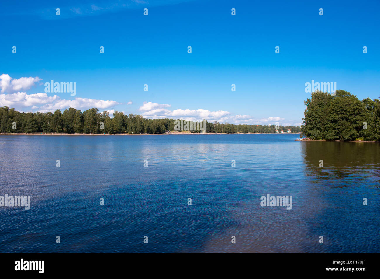 Coastline of Helsinki city during sunny summer day. Deep blue sky. Stock Photo