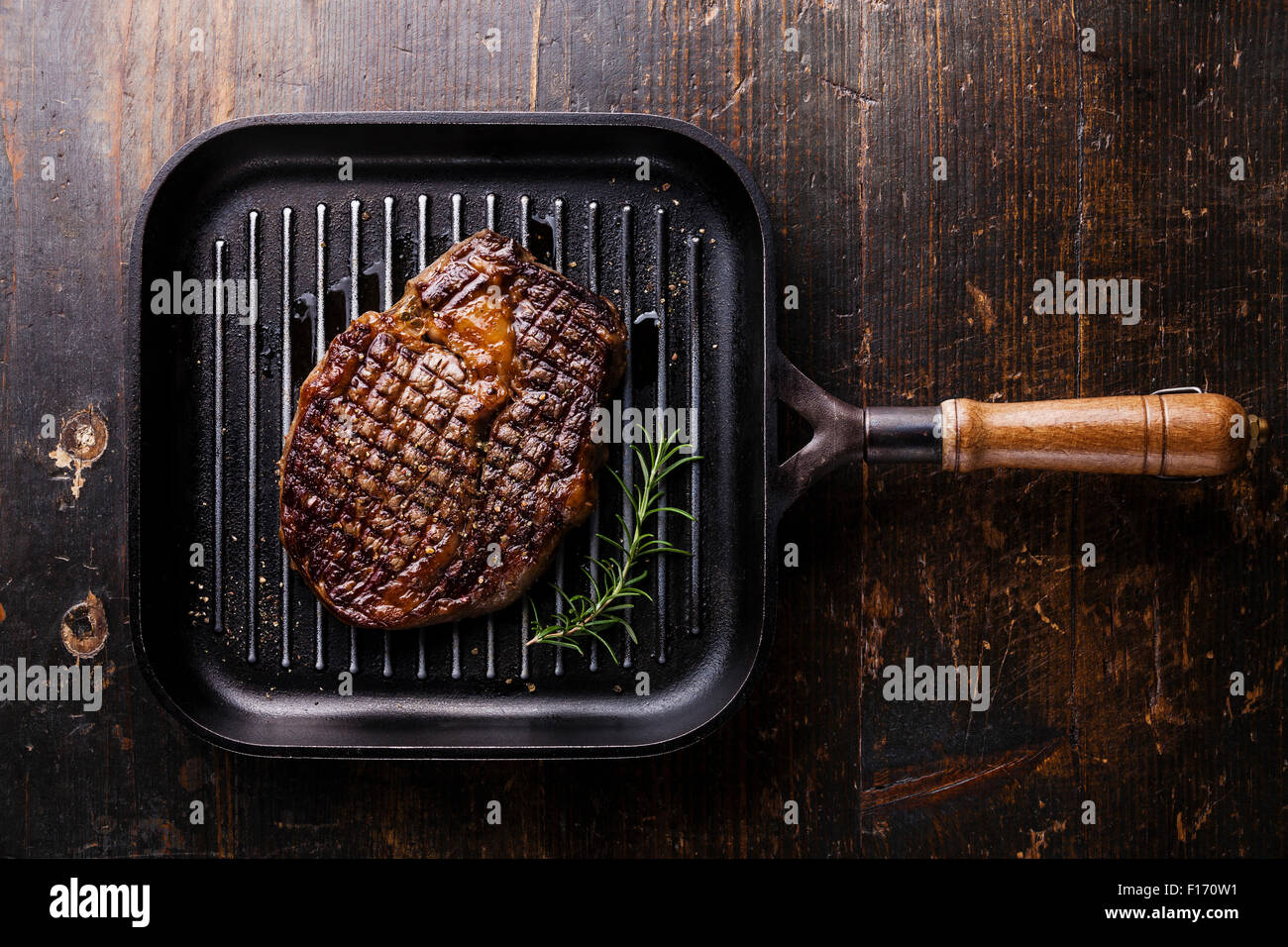 Grilled Black Angus Steak Ribeye on grill pan on wooden background Stock Photo