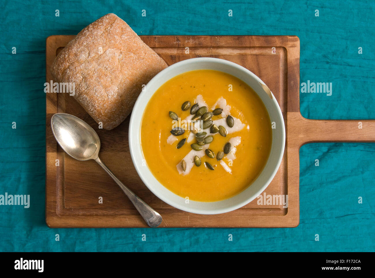 Squash soup with oregano, goats cheese and pumpkin seeds. Stock Photo