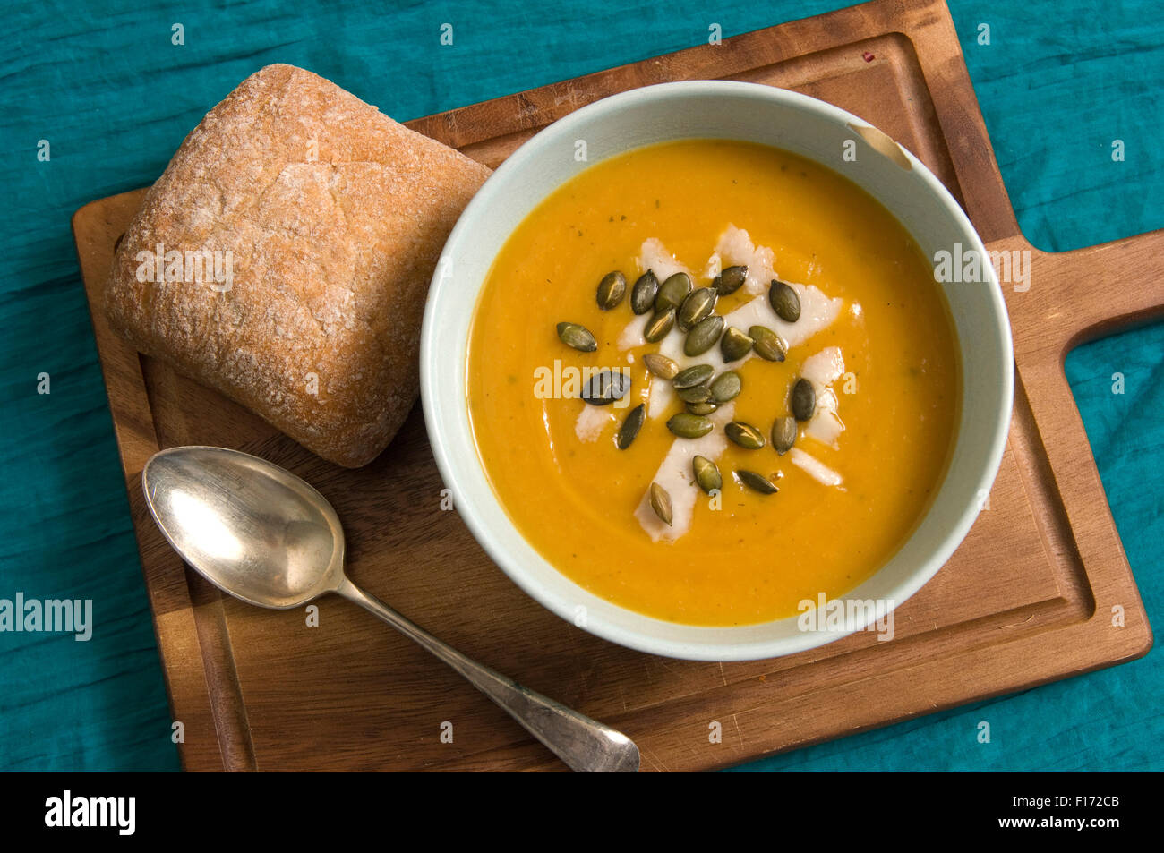 Squash soup with oregano, goats cheese and pumpkin seeds. Stock Photo