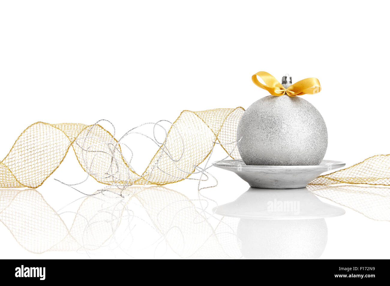 Silver Christmas ball with gold colored bow on white background Stock ...