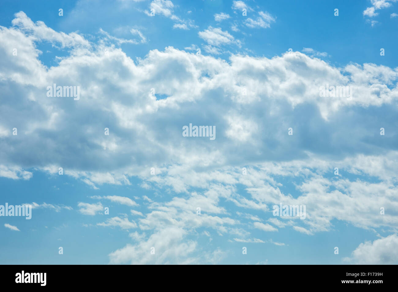 Blue sky and white fluffy clouds background Stock Photo - Alamy