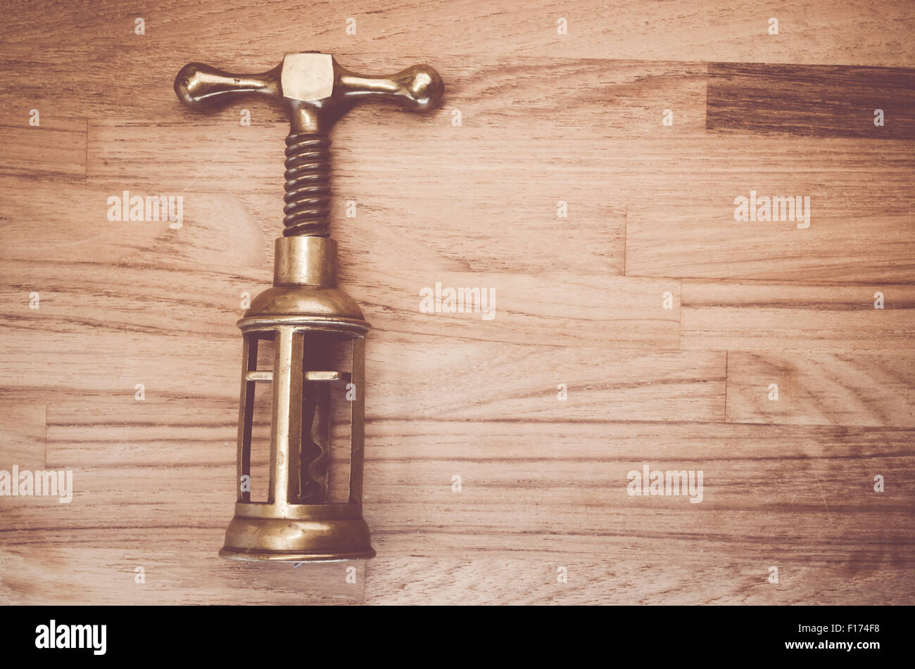 old hand made solid brass corkscrew on a natural wood background - kitchen  tools Stock Photo - Alamy