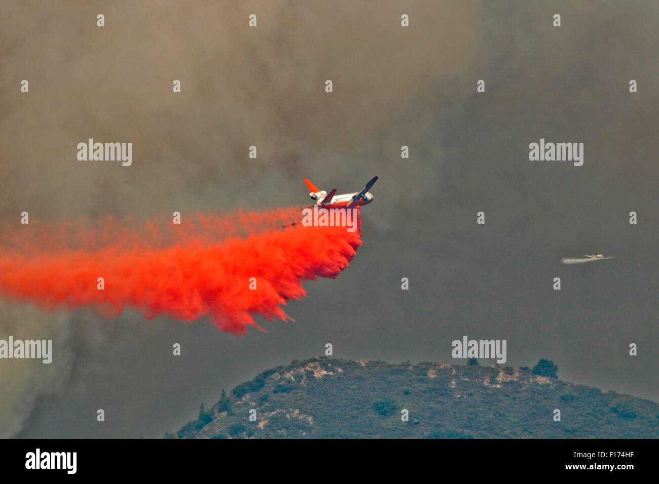 An super DC-10 air tanker drops fire retardant on the Rough Fire burning in the Sierra National Forest August 26, 2015 near Hume Lake, California. The fire caused by lightning has consumed an estimated 55,959 acres. Stock Photo