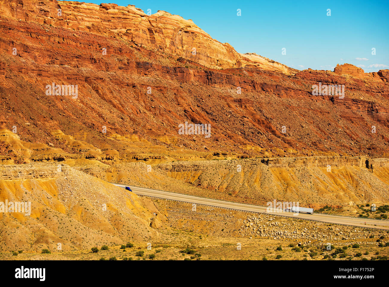 Trucks on the Utah Highway. Rocky Utah Wilderness Landscape. American Transportation Theme. Stock Photo