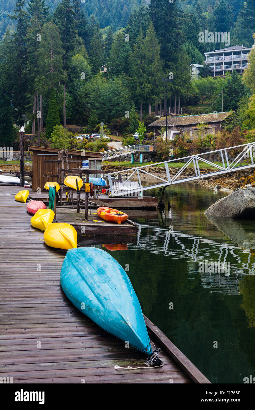 Kayaks lined up on a marina dock in Madeira Park on the Sunshine Coast, British Columbia Stock Photo