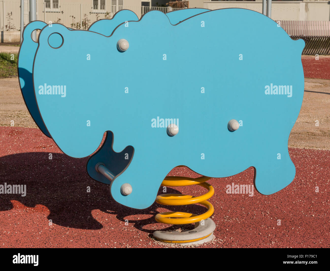 Bouncy colorful spring playground equipment in public park, plastic