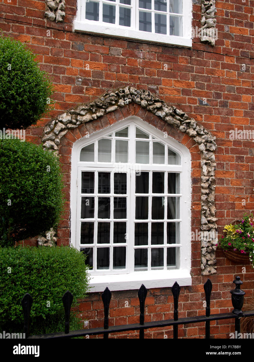 Stone flint arch around window, Marlborough, Wiltshire, UK Stock Photo