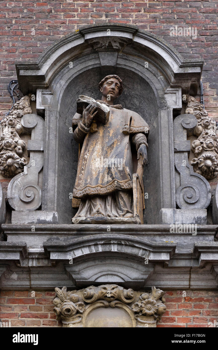 Sculpture of a monk in a facade above the door at the Sint Veerle plein in Ghend, Belgium Stock Photo