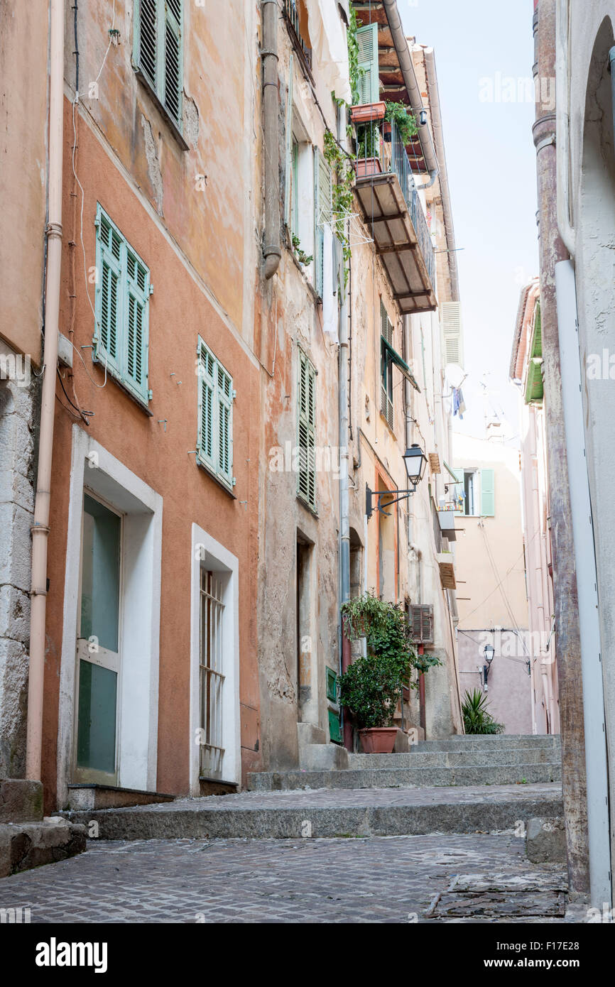 Narrow street with old buildings in medieval town Villefranche-sur-Mer on French Riviera, France. Stock Photo