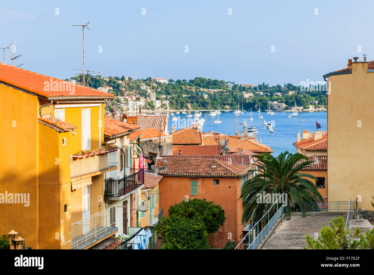 View of colorful rooftops and Mediterranean sea harbor with boats in old medieval town Villefranche-sur-Mer on French Riviera, F Stock Photo